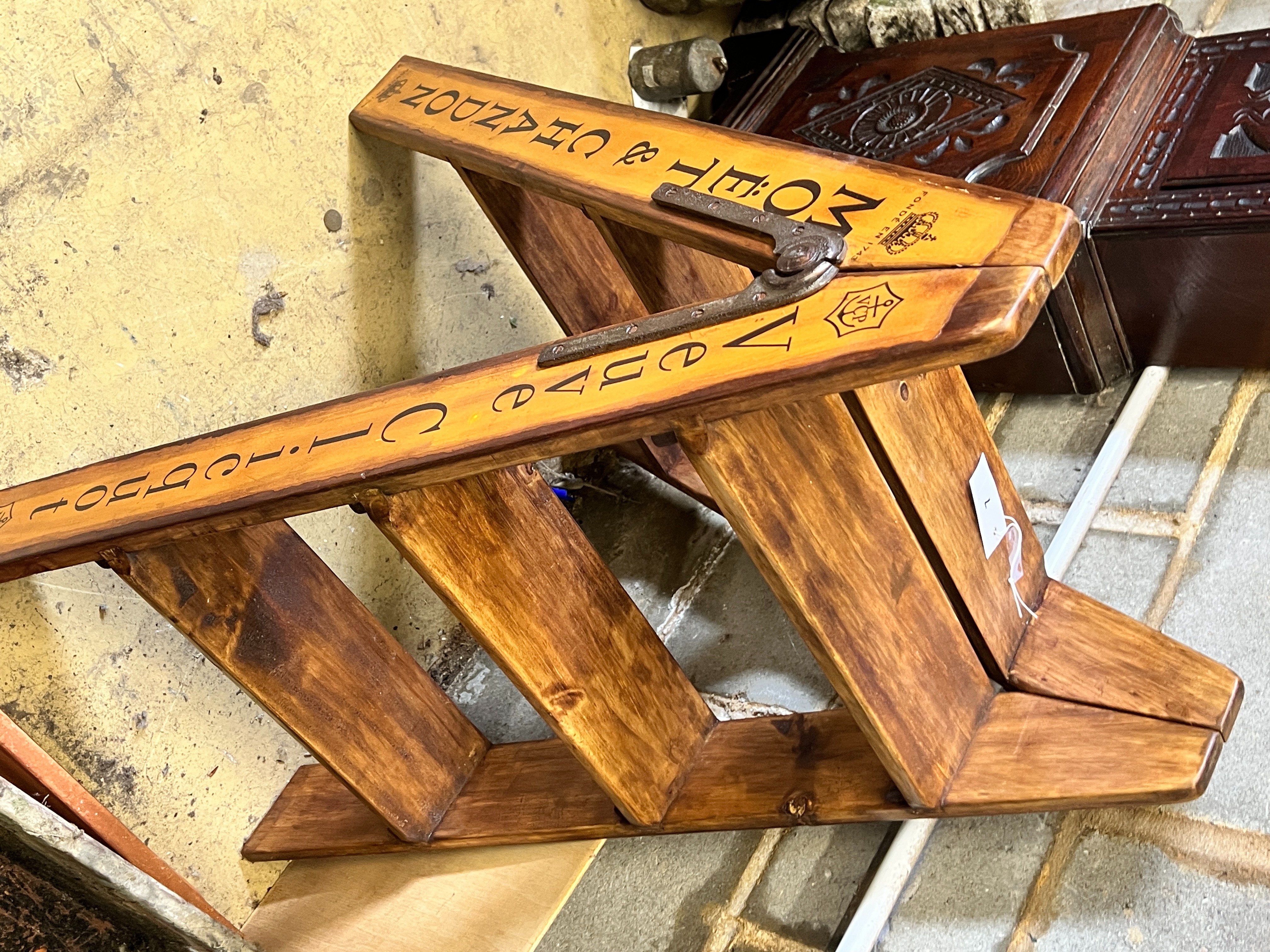 A pair of vintage style walnut folding cellar steps painted with champagne brands